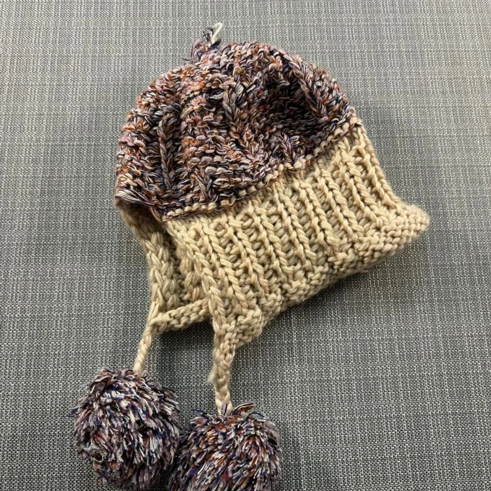 Multicolored knitted hat with pom poms